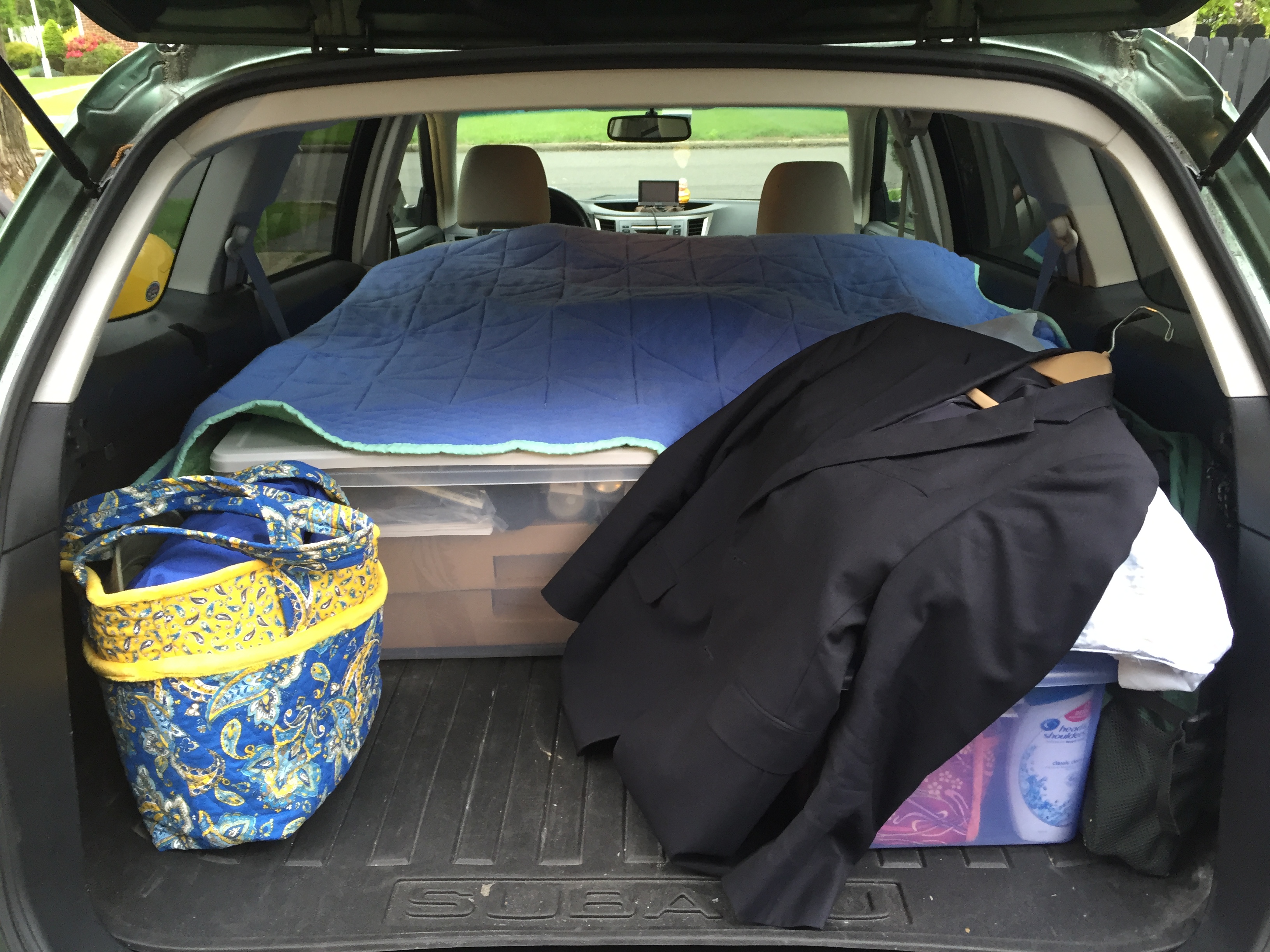 backend of car loaded with clothes for a trip